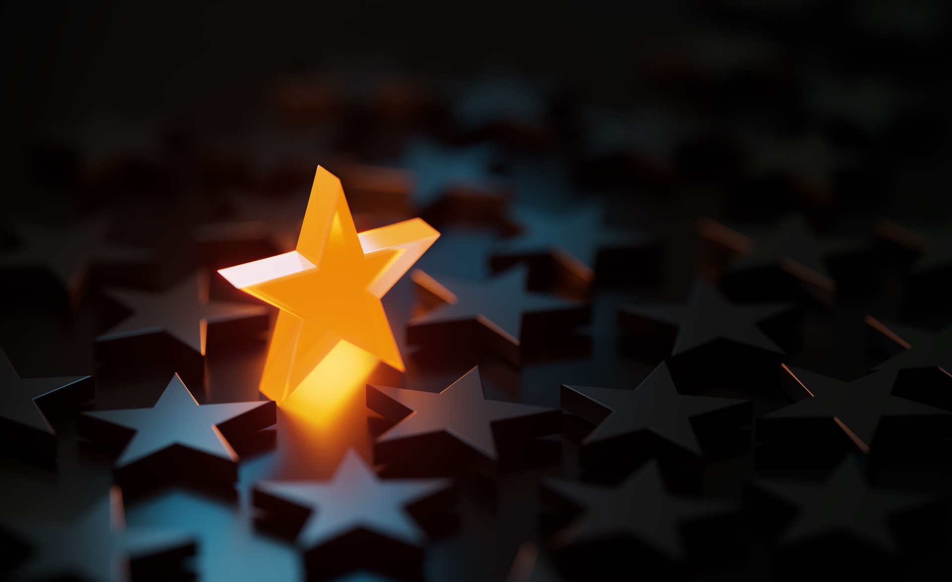 Orange Star Symbol Glowing Amid Black Star Symbols On Black Background